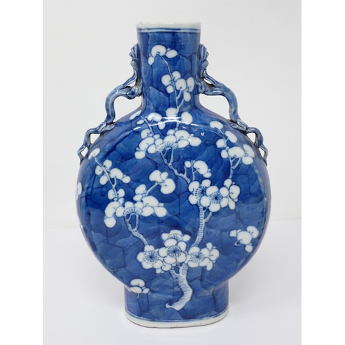 435 - A 19th Century Chinese Moon Flask Vase decorated prunus flowers in blue and white, 8¾in H, small rim... 