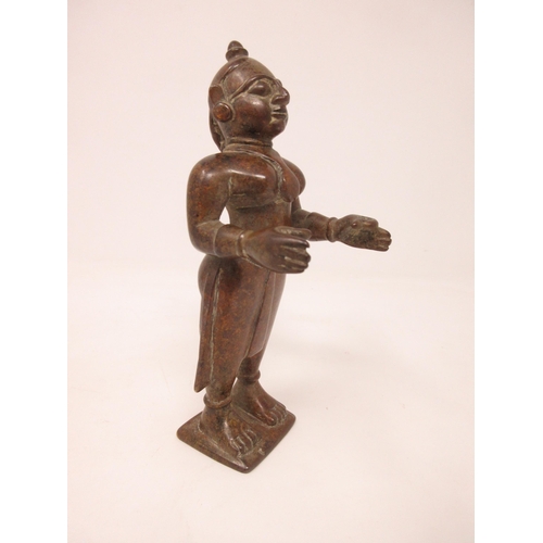 444 - An Indian/Tibetan bronze standing woman with plaited hair and outstretched arms, 6in