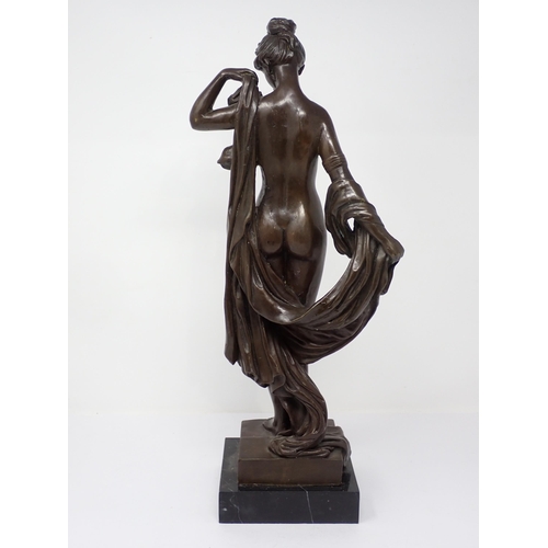 446 - A bronze Figure of a female standing nude on stepped base, 17in H