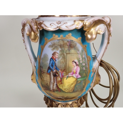 447 - A large porcelain and gilt metal two-handled Table Lamp decorated oval panels with lovers in a lands... 