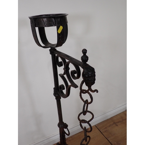 456 - An antique wrought iron central Fire Hearth Crane in the  16th Century style with pair of upright ca... 