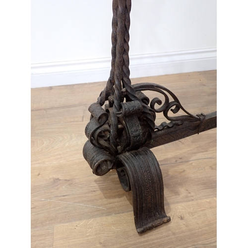 456 - An antique wrought iron central Fire Hearth Crane in the  16th Century style with pair of upright ca... 