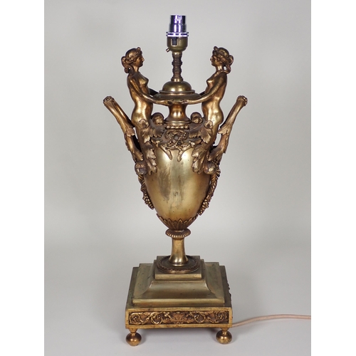 460 - A bronze two handled Table Lamp with figures holding bowl, the handles with leafage, rope twist and ... 