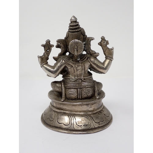 474 - A white metal Figure of Ganesh holding attributes on circular base, 6in H