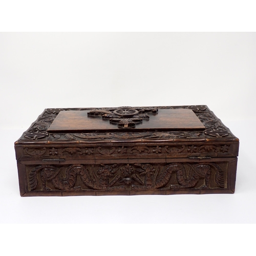 500 - A Kashmir carved Box, the hinged cover with relief carved motif for the Royal Artillery, surrounded ... 