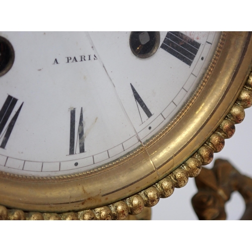 501 - A French Mantel Clock with cherub playing pipe supporting drum clock with white enamel dial, marked ... 