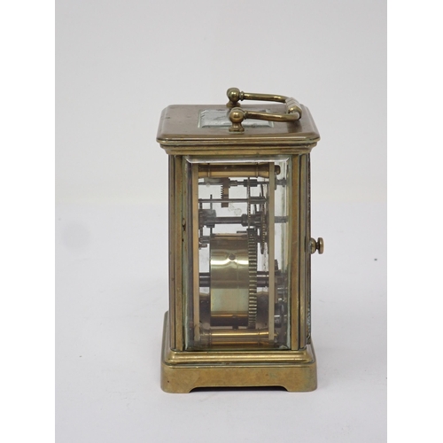 502 - A small French brass Carriage Clock, the white enamel dial marked with Roman numerals, 3½in H