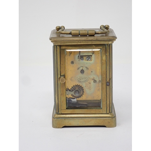 502 - A small French brass Carriage Clock, the white enamel dial marked with Roman numerals, 3½in H