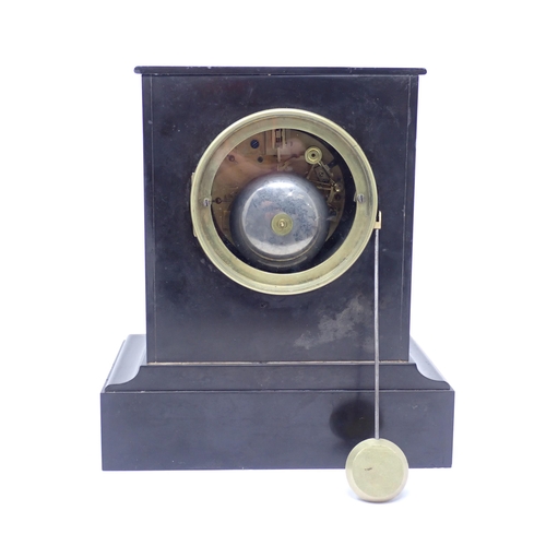 504 - A black marble Mantel Clock with engraved circular brass dial, inscribed Rollin A Paris, striking on... 