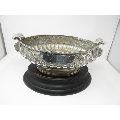 51 - An impressive large Victorian silver oval Bowl with floral and scroll embossing, mask handles, inscr... 