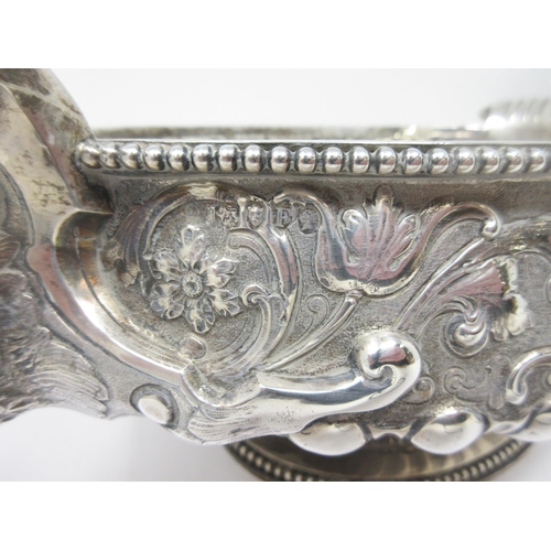 51 - An impressive large Victorian silver oval Bowl with floral and scroll embossing, mask handles, inscr... 