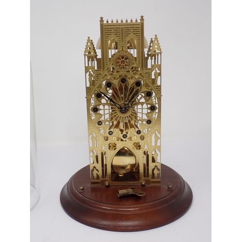 512 - A pierced brass Cathedral Skeleton Clock, the pierced dial marked with Roman numerals on black circu... 