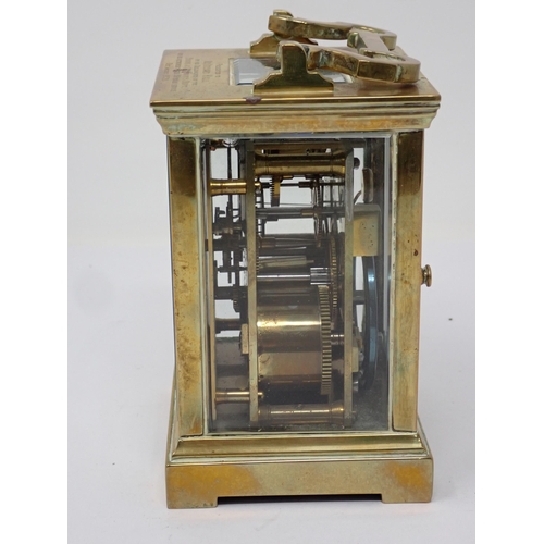 514 - A brass cased Carriage Clock, with presentation inscription to the top, the white enamel dial inscri... 