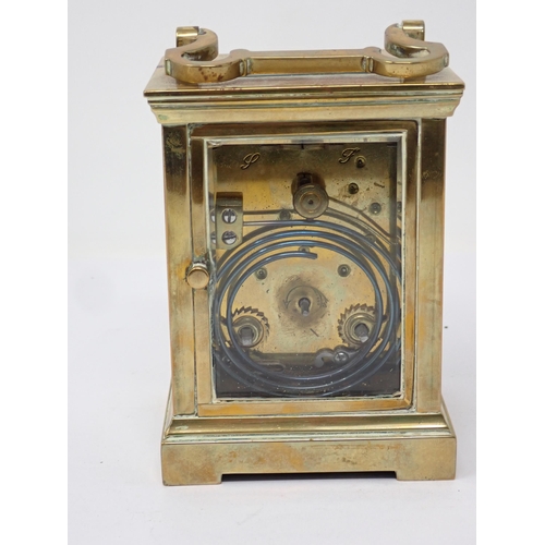 514 - A brass cased Carriage Clock, with presentation inscription to the top, the white enamel dial inscri... 