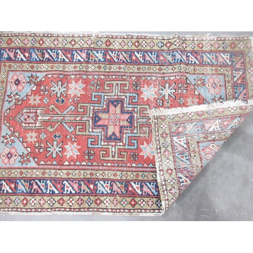 515 - A North West Persian small Rug with central arrowhead and latch hook medallion on a red ground, 3ft ... 