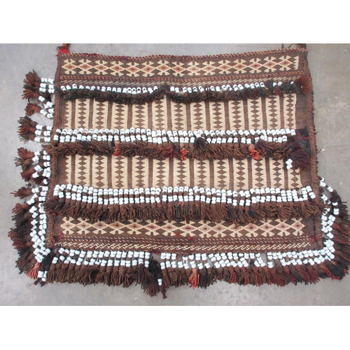 521 - An unusual Kelim Bag with rows of small diamonds in beige and brown, four rows of white ceramic bead... 