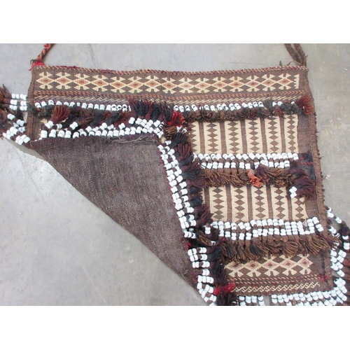 521 - An unusual Kelim Bag with rows of small diamonds in beige and brown, four rows of white ceramic bead... 