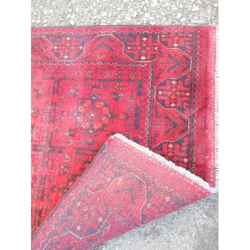 528 - A bordered Turcoman Rug with six guls on a red ground, 5ft x 3ft and a multi-bordered Prayer Rug, th... 