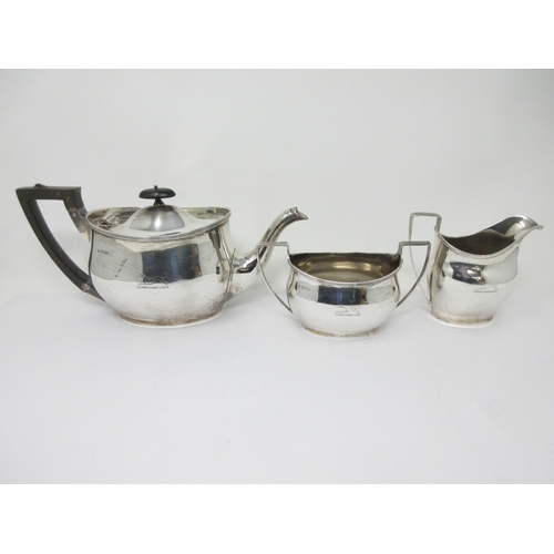 53 - A matched silver three-piece Tea Service of plain oval form, engraved Brownswood greyhound crest, Te... 