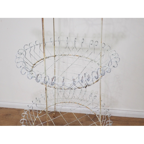 534 - A Victorian white painted wirework three tier circular Plant Stand 5ft 5in H x 2ft 7in D