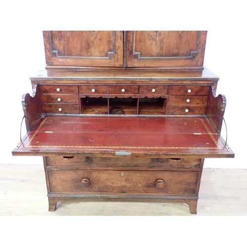 546 - An early 19th Century yew wood Secretaire Bookcase, the upper section with raised moulded panelled d... 