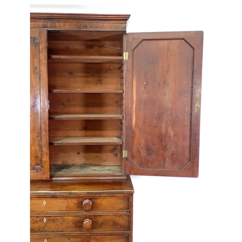 546 - An early 19th Century yew wood Secretaire Bookcase, the upper section with raised moulded panelled d... 