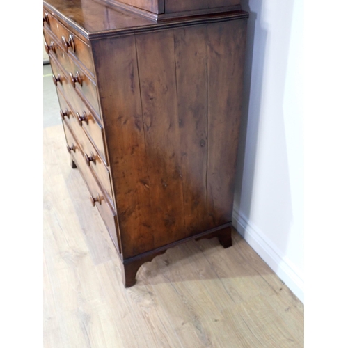 546 - An early 19th Century yew wood Secretaire Bookcase, the upper section with raised moulded panelled d... 