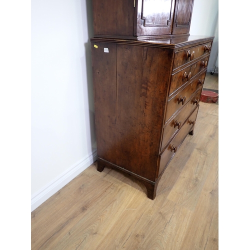 546 - An early 19th Century yew wood Secretaire Bookcase, the upper section with raised moulded panelled d... 