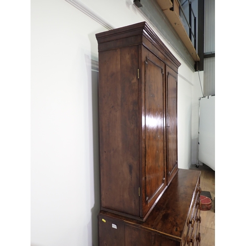 546 - An early 19th Century yew wood Secretaire Bookcase, the upper section with raised moulded panelled d... 