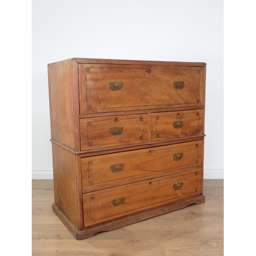 557 - An early 19th Century camphor Campaign Secretaire Chest, in two sections, with brass inset handles a... 