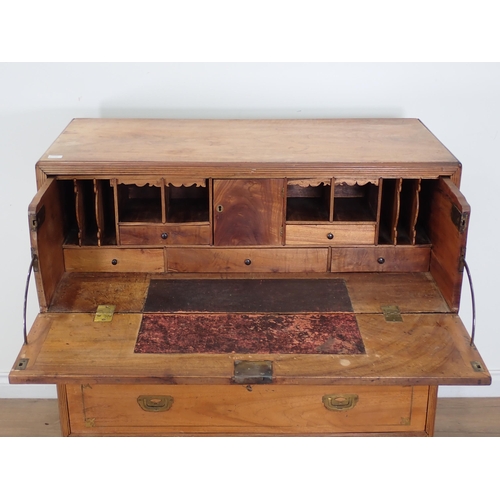 557 - An early 19th Century camphor Campaign Secretaire Chest, in two sections, with brass inset handles a... 