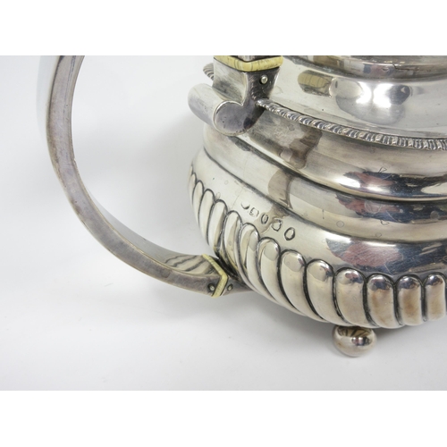 56 - A George IV silver three-piece Tea Service of boat shape with gadroon embossing and rims, on ball fe... 