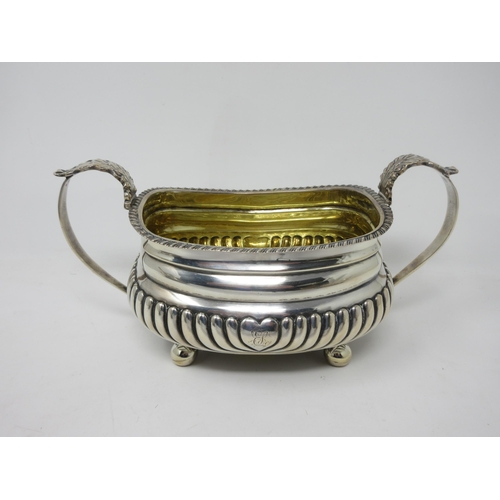 56 - A George IV silver three-piece Tea Service of boat shape with gadroon embossing and rims, on ball fe... 