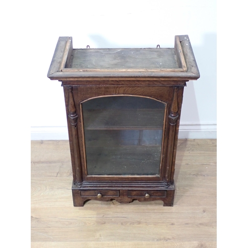 563 - A 19th Century Welsh oak Cabinet fitted single glazed door between moulded half pilasters above sing... 