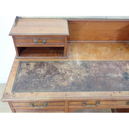 567 - A Victorian walnut Kneehole Desk by Gillows & Co. fitted two drawers to raised back above two banks ... 