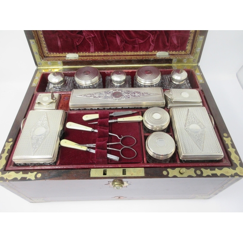 6 - An early Victorian rosewood Dressing Case with brass inlay, the interior with numerous silver lidded... 