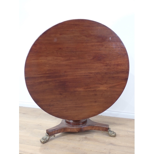 600 - A 19th Century mahogany Breakfast Table with tilting circular top on turned column, the triform base... 