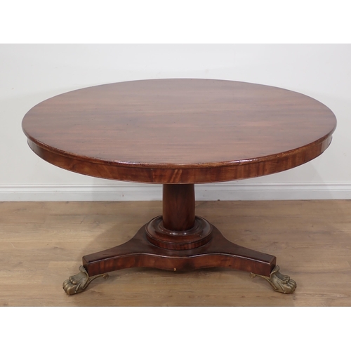 600 - A 19th Century mahogany Breakfast Table with tilting circular top on turned column, the triform base... 