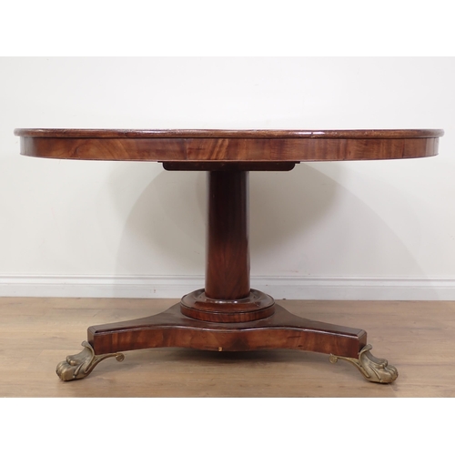 600 - A 19th Century mahogany Breakfast Table with tilting circular top on turned column, the triform base... 