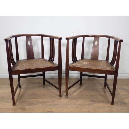 605 - A pair of Glasgow School Arts and Crafts Elbow Chairs with pierced splat backs, rush drop-in seats o... 