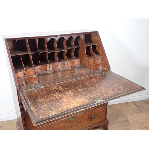 607 - A George III oak Bureau with fielded fall front enclosing pigeon holes and drawers above two short a... 