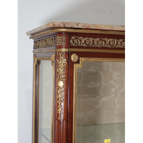 609 - A French Vitrine with marble top, the kingwood frame having ormolu mounts with scrolled leafage and ... 