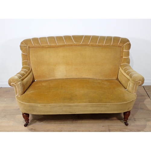 611 - A Victorian small Settee with scrolled arms on turned supports and casters 4ft 10in W