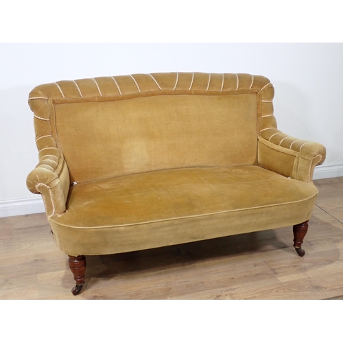 611 - A Victorian small Settee with scrolled arms on turned supports and casters 4ft 10in W