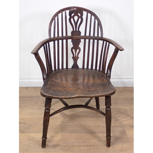 615 - An early 19th Century yew and elm Windsor Elbow Chair with pierced splat back, on turned supports an... 