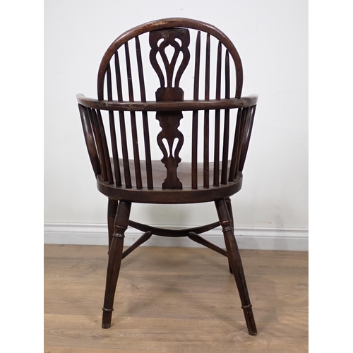 615 - An early 19th Century yew and elm Windsor Elbow Chair with pierced splat back, on turned supports an... 