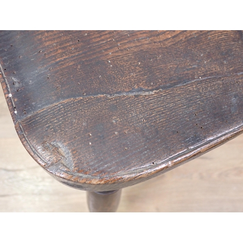 615 - An early 19th Century yew and elm Windsor Elbow Chair with pierced splat back, on turned supports an... 