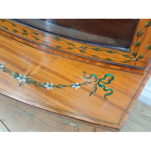 625 - A satinwood bow fronted glazed Cabinet with arched pediment, the upper section fitted adjustable she... 