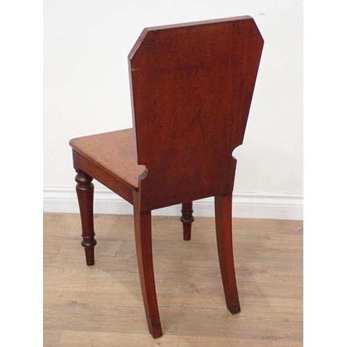 628 - A mid 19th Century Set of four mahogany Hall Chairs, the shaped rectangular backs with oval panels a... 