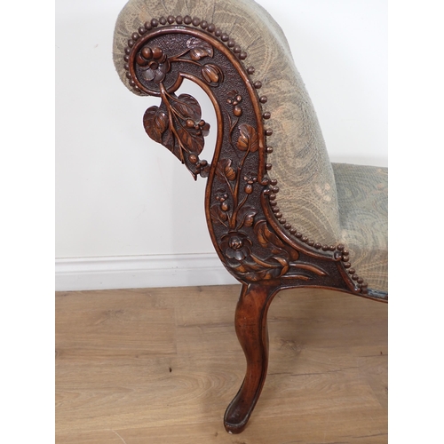 629 - A 19th Century mahogany Chaise of short proportions with flowering branch carving to the scroll end ... 